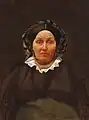 A 19th century Belarusian Jewish woman wearing a wig underneath a silk cap or bonnet