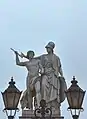 Athena teaches the young man how to use a weapon