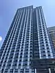 1 North 4th Place, a high-rise clad in blue glass, viewed from street level