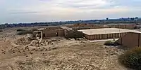 The reconstructed "platform" (right) before the axial stairway of the ziggurat. The temple complex appear