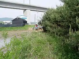 Tractor passing under the KTX line in Yacheon-ri, Hwaseong37°14′49″N 126°55′17″E﻿ / ﻿37.24694°N 126.92139°E﻿ / 37.24694; 126.92139