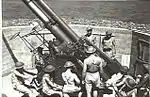Gunners working on 3.7-inch (94 mm) heavy anti-aircraft gun. 1943.