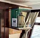  Ship’s bell in display case in ship’s bar.