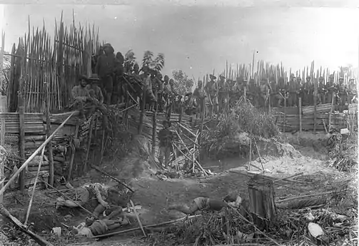Dutch troops at the fortified village of Kute Rih with dead Alas people