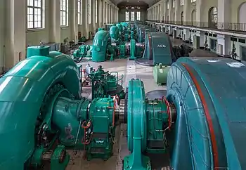 Image 2Walchensee Hydroelectric Power StationPhotograph credit: Diego DelsoThe Walchensee Hydroelectric Power Station is a storage power station in Bavaria, Germany. The turbines, seen here, are fed by water from the Walchensee which is then released into the Kochelsee. The power station uses the hydraulic head of about 200 metres (660 ft) between the two natural lakes, and water from the Rißbach river is also used to augment the supply. The installed capacity is 124 MW with an annual production of 300 GWh; this is one of the largest of such power plants in Germany.