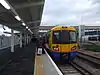 An overground train terminates at Clapham Junction