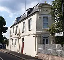 A corner house with end pediment and swag,Church Path