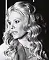 Promotional photograph of Delphine Seyrig for The Garden of Delights. She is looking to the left with curly hair.
