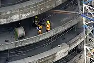 This is a photo of Dubai Civil Defense vehicles at the base of the under-construction Fortune Executive Tower (located in Jumeirah Lake Towers in Dubai, United Arab Emirates) due to a fire there on 15 June 2008.