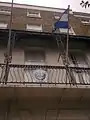 The Salvadoran flag and coat of arms outside the embassy