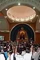 Devotees of St Thérèse hold up roses to be blessed. The flower is symbolic of the saint's intercession.