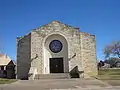 The architecture of the First Baptist Church resembles a fort or other western structure.