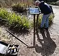 Tamping a new information signpost into place