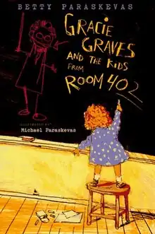 A schoolgirl drawing on a blackboard inside a classroom