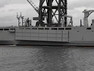 A Mexeflote suspended from the starboard flank of HMAS&nbsp;Choules