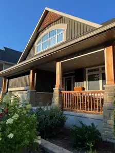 a) Board-and-Battan siding, b) Square-post ornamentation, c) Shingle-style, gable apex ornamentation, d) Front verandah (built, 2006)