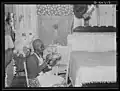 Woman sewing chair covers, bedspread, and other things made from cotton flour sacks in Alabama