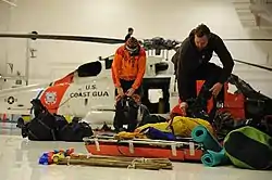Juneau Mountain Rescue members prepare gear for a rescue mission, facilitated by the US Coast Guard, in 2011