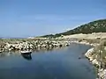 Kalogria beach. The small river Larissos connecting the lagoon of Prokopos and the Ionian sea. In the background the large sand dune of the beach.