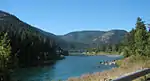 A large river flowing through forested hills