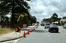 Cone taper for left lane closure in Western Australia showing small chevron (shifter), 40&nbsp;km/h repeater, chevron and arrow-board