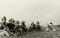 Colonial troops of the Thang-long Regiment, national guard, about to go into battle, December 1946. One of them has a Japanese helmet.