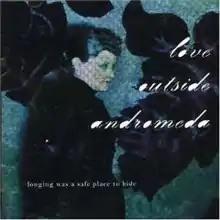 A woman is shown in upper body shot and side profile. She has dark hair and wears dark clothes. The background depicts large, purple-black flowers over green-blue dappled screen. The group's name is written in large, white coloured lower case script at middle right. The title is printed in small lower case type at bottom left.