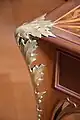 Decoration of a thistle leaf on a desk corner.