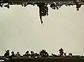 Artistic view of a Mardi Gras krewe member throwing a Mardi Gras Doubloon