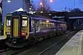 A Northern Rail Class 156 waits at the station.