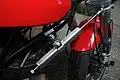 An aftermarket steering damper attached below the lower triple clamp