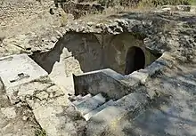 Exterior view of access to an underground building with the beginning of a staircase