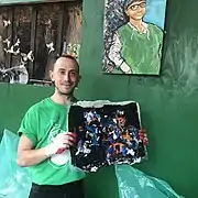 Sure We Can employee holds a sample sheet of the upcycled plastic film product the redemption center is working on.