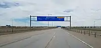 Terminal East gantry sign at Denver International Airport (DIA) with an empty freeway during the pandemic.