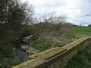 The River Wiske flowing under the old A167 bridge.54°25′36″N 1°27′54″W﻿ / ﻿54.426645°N 1.465125°W﻿ / 54.426645; -1.465125