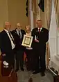 Eoghan Ganly, President of the Maritime Institute of Ireland (wearing chain of office) at Medal presentation to the grandchildren of Timoteo McCarthy, an Argentine national who served on a number of Irish ships in the war.