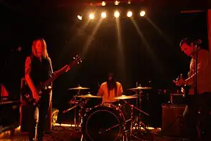True Widow, performing live in Berlin in 2010, from left to right: Nicole Estill, Timothy Starks and Dan Phillips