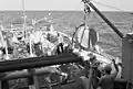 USS Illusive lowers an acoustical device during an exercise.