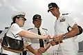 Captain Jeff Bartkoski of USS Blue Ridge presents a command coin to Sanming on 28 June 2006