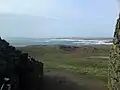 View from the entrance, surf in Cymyran Bay