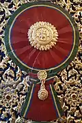 A woodcarving of "Maha Varabhorn", the Knight Grand Cross (First Class) of the Order of the White Elephant, version that used from 1869 to 1909, at gates of Phra Vihara of Wat Ratchabophit Sathit Maha Simaram, Bangkok.
